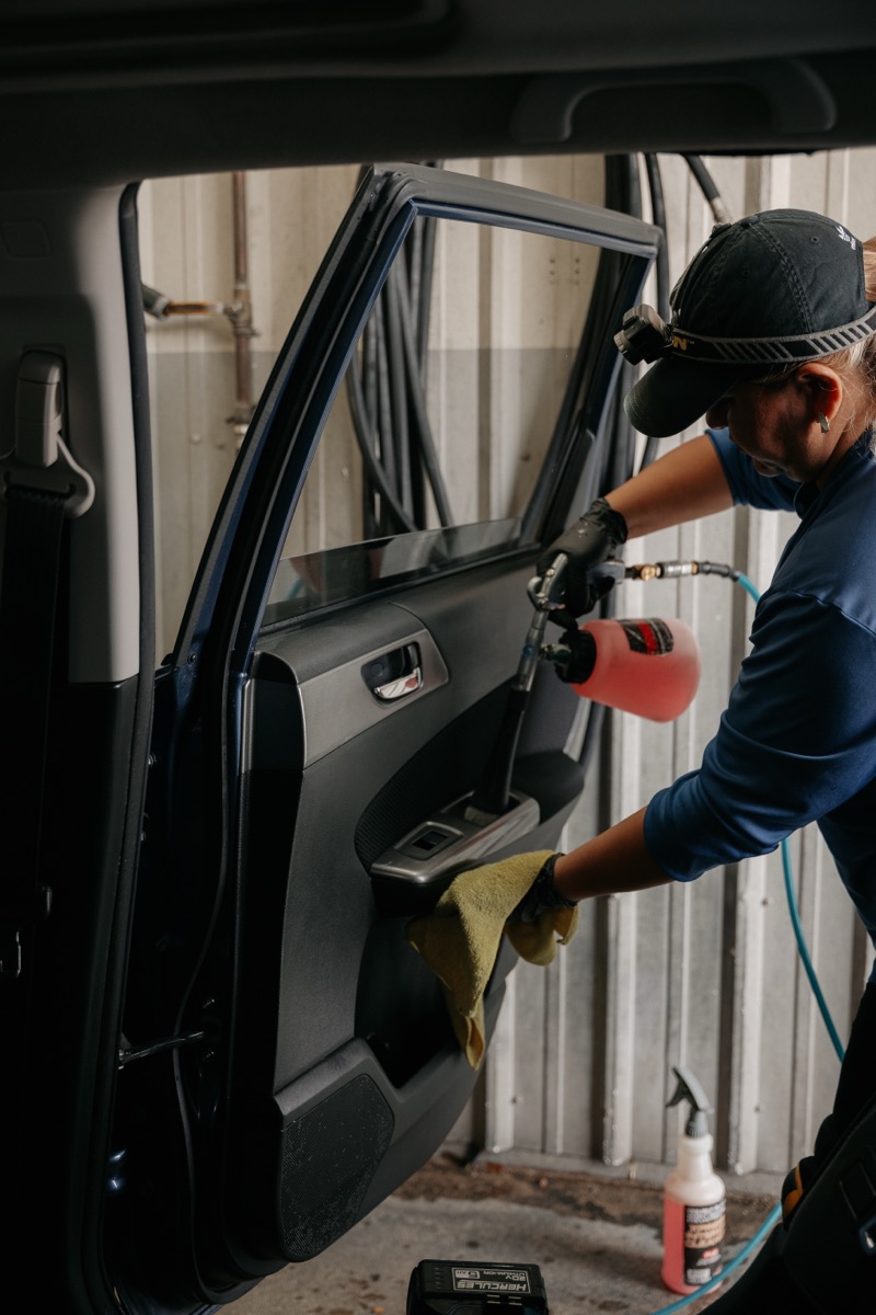 Cleaning car door panel with spray bottle