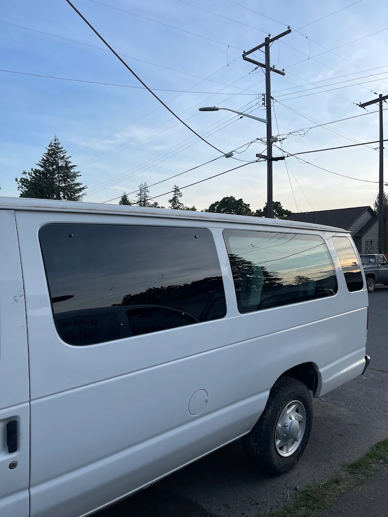 White Ford van with completed side window replacement by New Delta Auto Glass